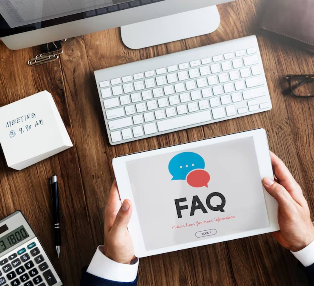 Three wooden blocks on a table spelling out FAQ.